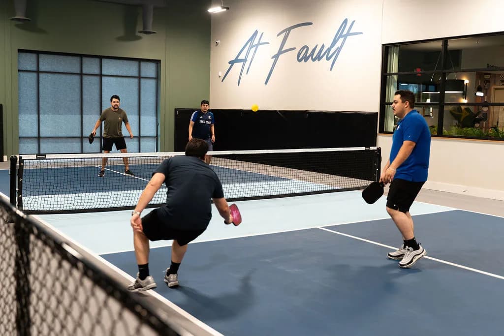 Players on the indoor pickleball courts at At Fault