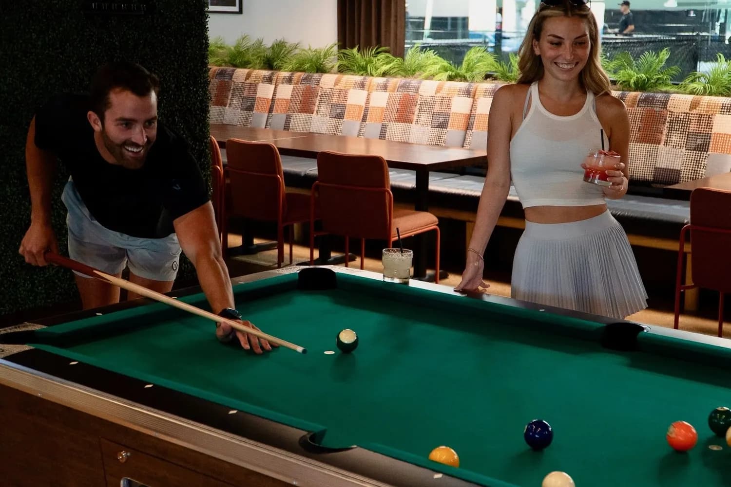 Guests playing pool at At Fault