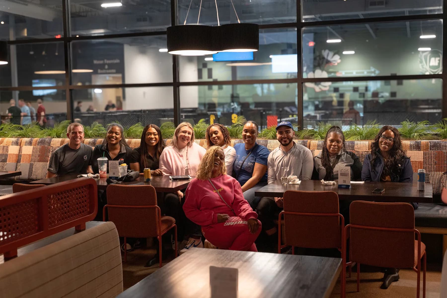 Group of friends sharing dinner and drinks at At Fault