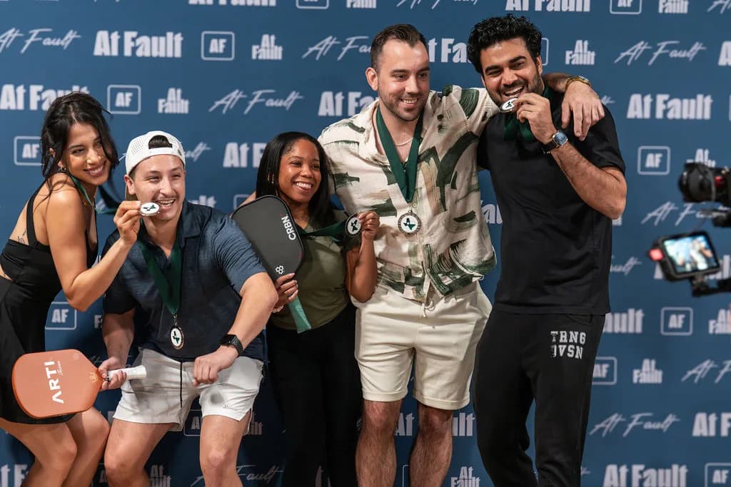 Pickleball tournament winners celebrating with medals at At Fault
