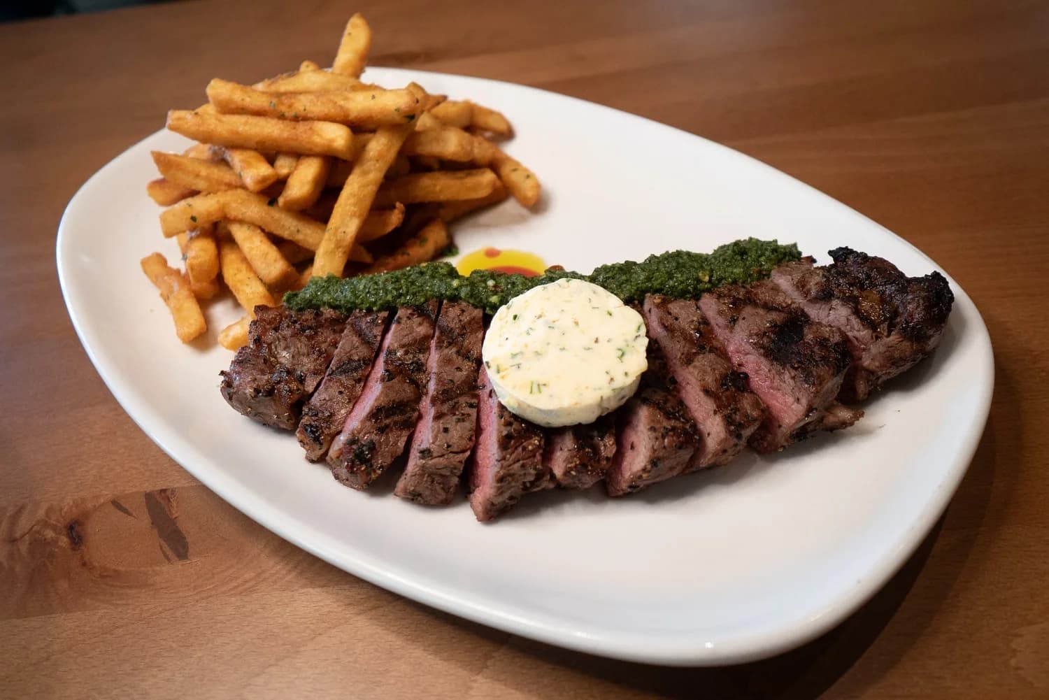 Sliced grilled steak with herb butter