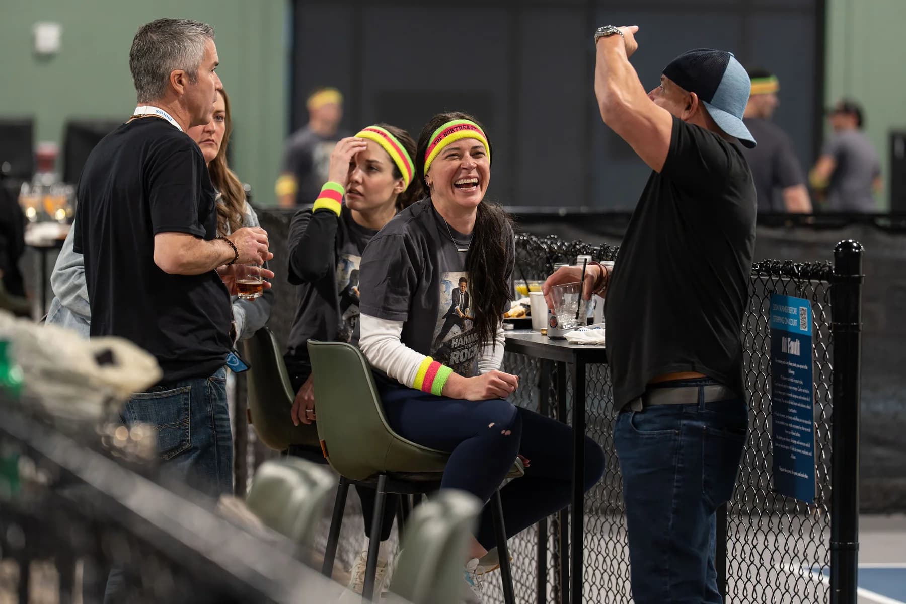 Guests cheering next to the pickleball courts during a private event at At Fault